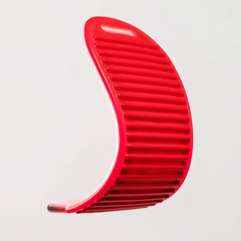 Red comb with textured grip for styling and detangling hair.
